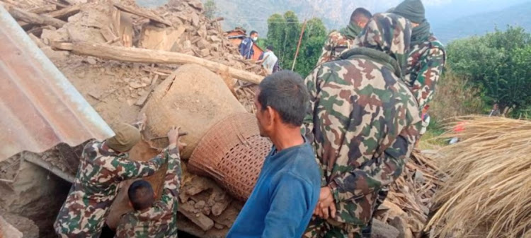 Members of the Nepal army work during a rescue operation at the ruins of a collapsed house, damaged after an earthquake struck early Wednesday, in the western district of Doti, Nepal November 9, 2022.