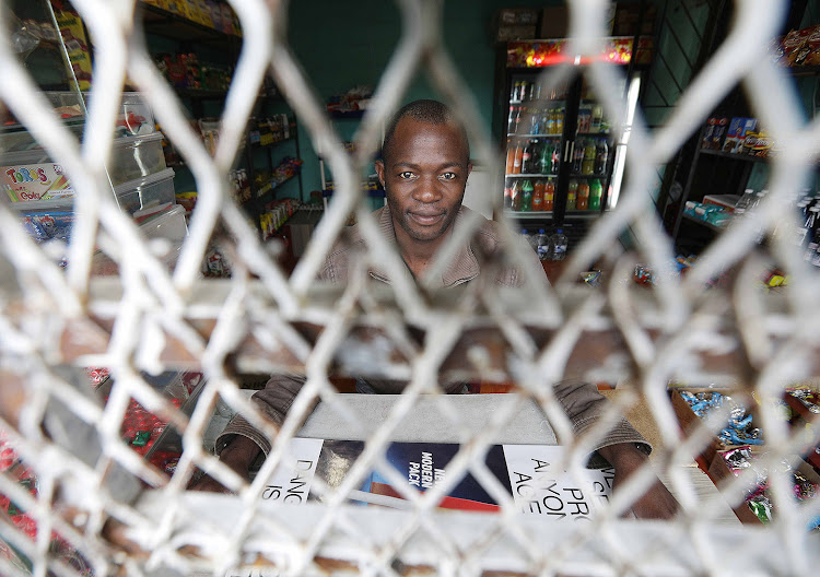 Osman Mofo, 35, in his spaza shop in Nyanga.