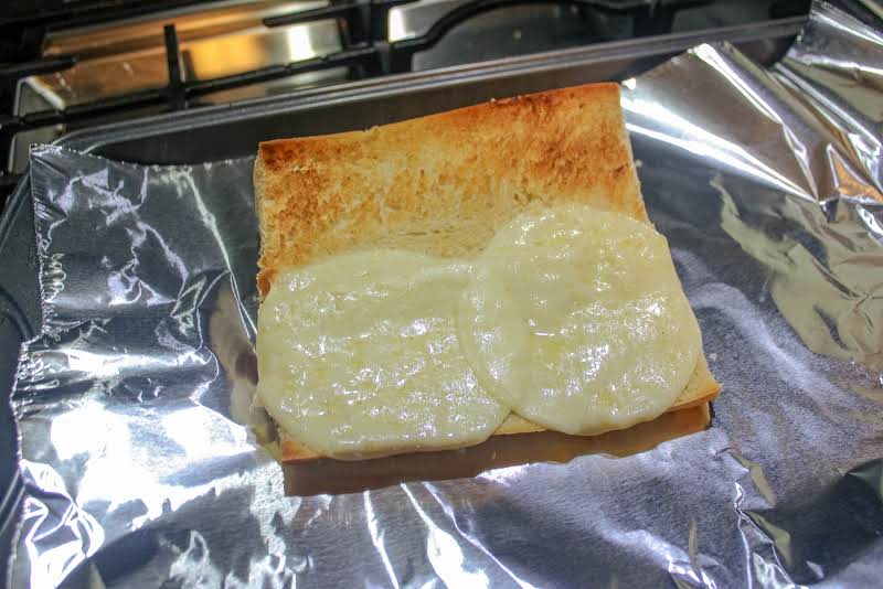 Toasting Provolone Cheese On French Bread.