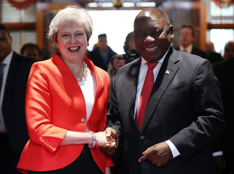 Britain's Prime Minister Theresa May is greeted by South African President Cyril Ramaphosa in Cape Town, South Africa, August 28, 2018.