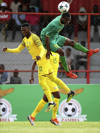 Clive Rupiya of Zimbabwe, right, battles for the ball with James Monyane of SA. / Chris Ricco/BackpagePix