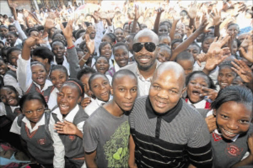 FÊTED: Kutloano Modise, grey T-Shirt, and DJ Sbu, in glasses, in Katlehong yesterday. PHOTO: VELI NHLAPO