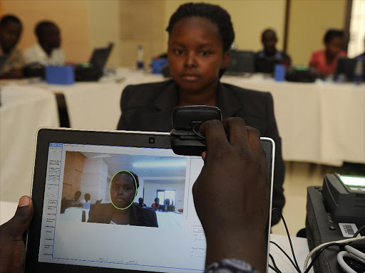 An Independent Electoral and Boundaries Commission (IEBC) agent demonstrates the use of newly acquired Biometric Voter Registration (BVR) kit at the Moi International Sports Centre in Kasarani, Nairobi on November 6, 2012./FILE