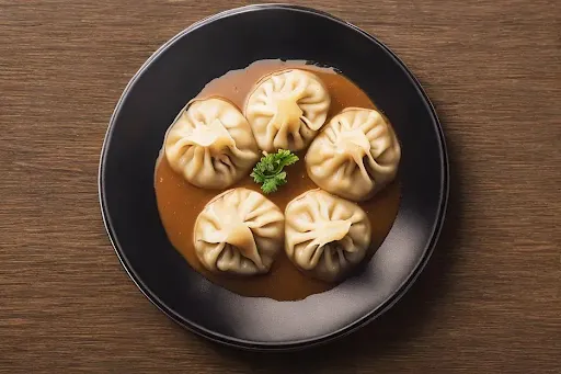 Chicken Momos [5 Pieces] With Tossed Into Sauce