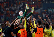 Bafana players celebrate with coach Hugo Broos after winning the penalty shootout against DR Congo in the Africa Cup of Nations’ third-place playoff at Stade Felix
Houphouet-Boigny Stadium in Abidjan, Ivory Coast. 