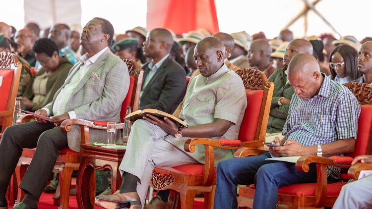 President William Ruto reads his bible when he joined other faithful for interdenominational prayers at Mwatunge grounds in Taita Taveta county on July 23, 2023