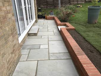 Indian stone patio in kandala grey / steps and dwarf wall in red bricks   album cover