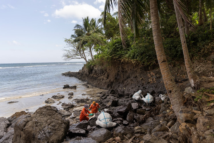 Volunteers and coastguard personnel dressed in personal protective equipment clean up the oil spill from the sunken fuel tanker MT Princess Empress, on the shore of Pola, Oriental Mindoro province, Philippines, March 7, 2023.