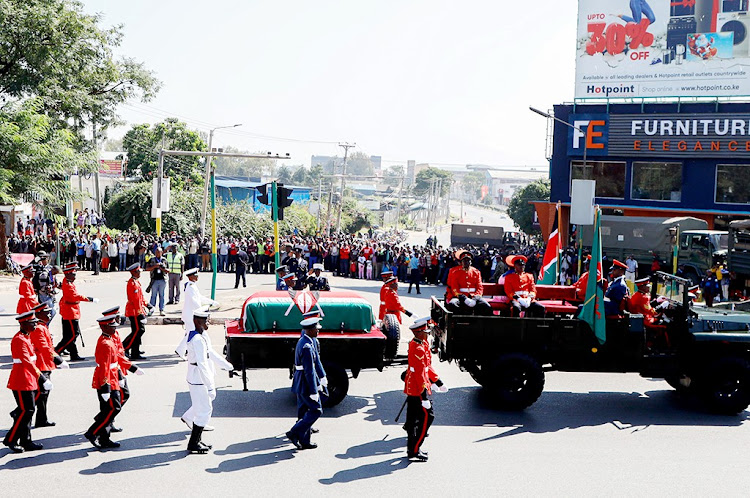 A procession of military officers escorts the coffin carrying the body of Kenya's second president Daniel Moi towards Nyayo Stadium for a public funeral service on February 11, 2020.