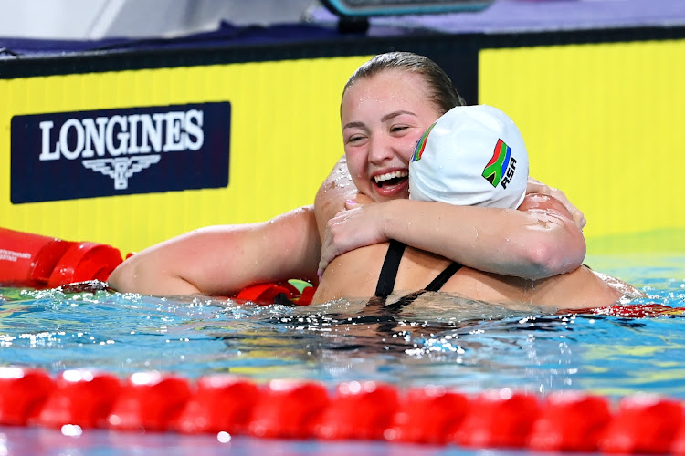 Lara van Niekerk is congratulated by teammate Kaylene Corbett after clocking another Games record in the 50m breaststroke semifinals in Birmingham on Friday.