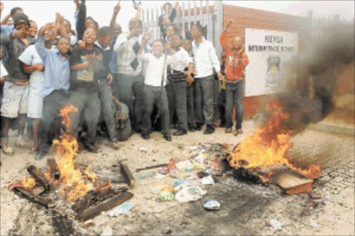 YOUTH RAGE: Pupils at Kuyga Intermediate School in Eastern Cape burn tyres during a protest over the dire shortage of teachers. Photo: JUDY DE VEGA