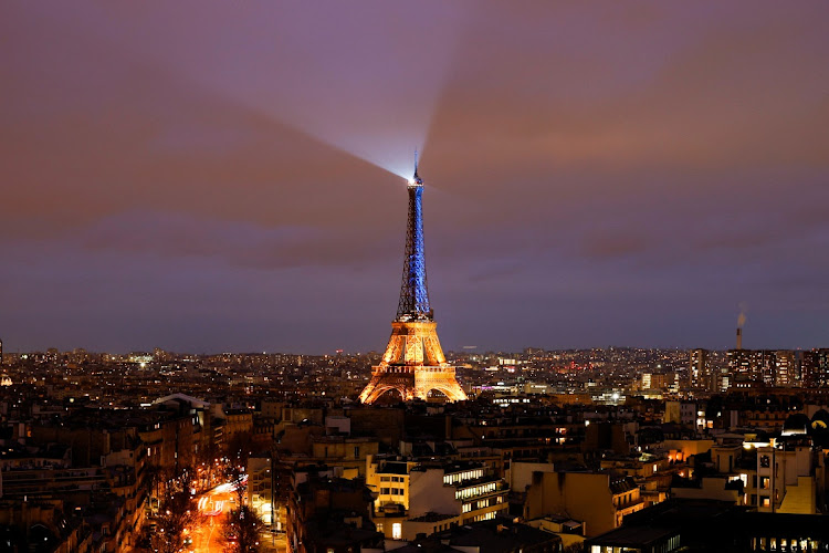 The Eiffel Tower is lit up in the national blue-and-yellow colours of Ukraine, to mark the first anniversary of Russia's invasion of Ukraine, in Paris, France, February 23, 2023.