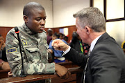 #FeesMustFall activist Bonginkosi Khanyile consults his advocate, Danie Combrink, before he was sentenced in Durban last Monday.