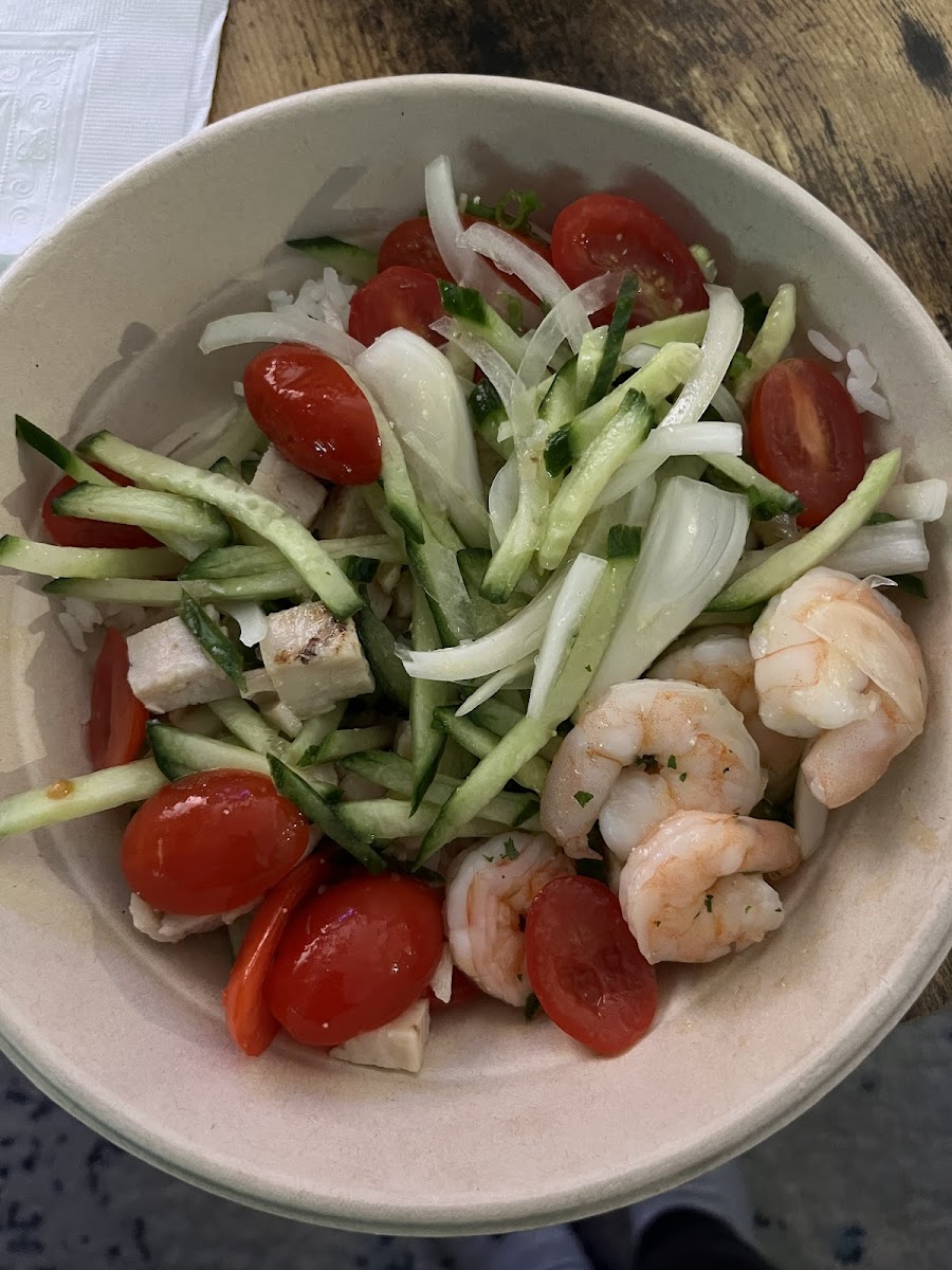 Create your own bowel! White rice, chicken, cooked shrimp, cherry tomatoes, cucumber, green onions, sweet onion, cilantro with lemok ginger sauce