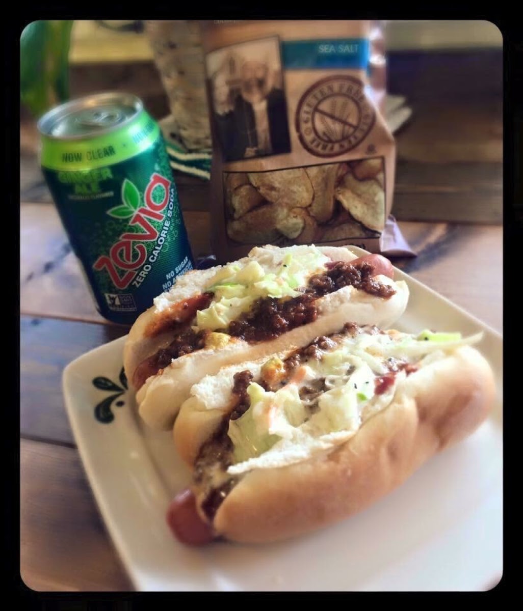 All natural grassfed beef hotdogs on gluten free buns topped witj grassfed beef sauce and coleslaw.