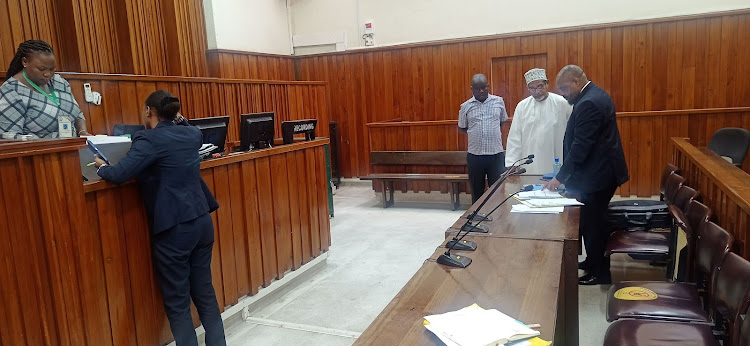 Muhuri director Khelef Khalifa consults with lawyer Mbugua Mureithi at the Mombasa High Court.