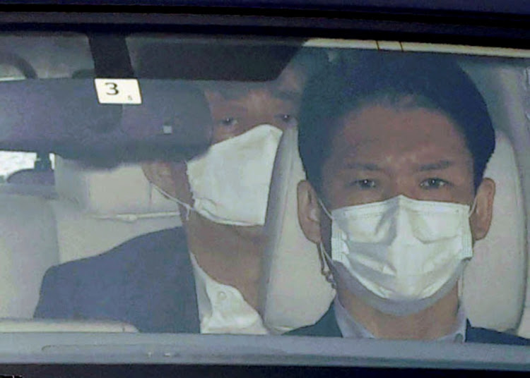 Japanese Prime Minister Shinzo Abe, behind, arrives by a car at Keio University Hospital in Tokyo, Japan, on Monday, amid speculation about his health.