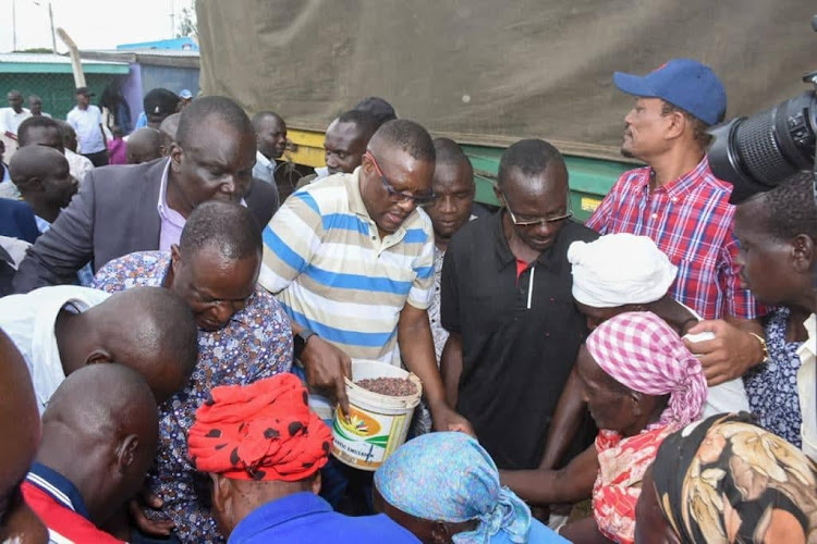 ICT CS Eliud Owalo leads a food distribution drive at Aram Market in Rarieda constituency, Siaya county on November 12, 2022