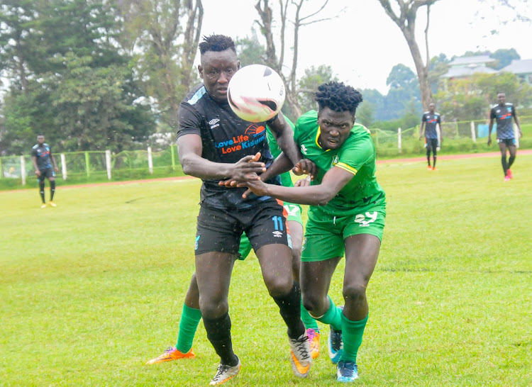 Tony Nyangor of Kisumu All Stars battles for the ball against Zoo Kericho's Kepher Ondati during an NSL game