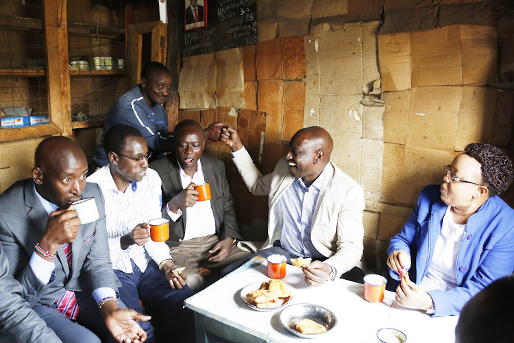 Deputy President William Ruto with other leaders enjoy a tea and maandazi during a visit to Nyandarua County on June 9, 2019.