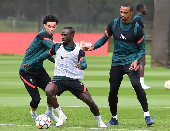 Liverpool and Senegal star Sadio Mane challenged by Curtis Jones (left) and Joel Matip during their training session at AXA Training Centre on May 25 2022 in England.