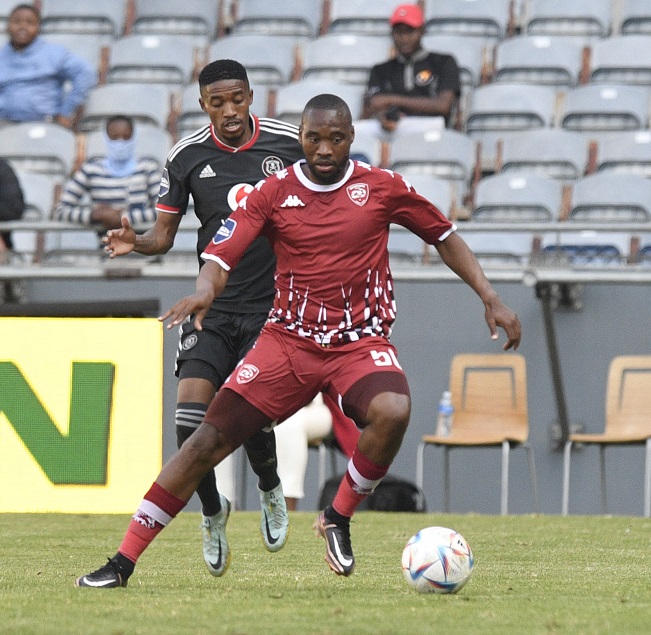 Sekhukhune United midfielder Sibusiso Vilakazi challenged by Monnapule Saleng of Orlando Pirates during their DStv Premiership match at Orlando Stadium.