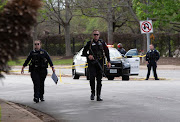 Austin police officers investigate at the scene of a deadly shooting at an apartment complex in Austin, Texas, US, April 18, 2021. 