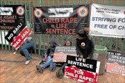 FIRM: Protesters outside the Roodepoort Magistrate's Court during the appearance of seven males accused of raping and recording the rape of a mentally handicapped young woman.  Photo: ALON SKUY