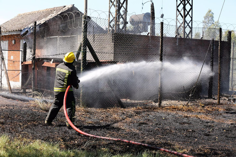 A firefighter helps put out the blaze after a transformer exploded near the St Albans prison on Wednesday afternoon