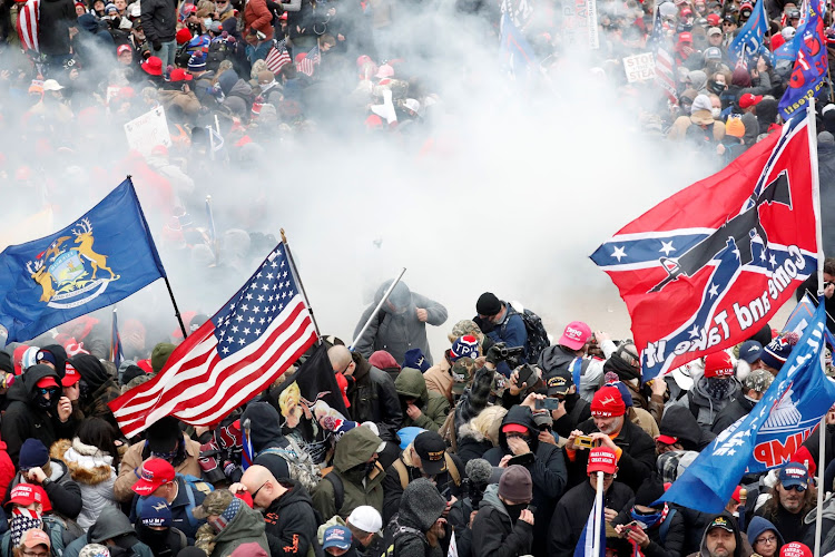 Tear gas is released into a crowd of protesters during clashes with Capitol police at a rally to contest the certification of the 2020 U.S. presidential election results by the U.S. Congress, at the U.S. Capitol Building in Washington, U.S, January 6, 2021. REUTERS/Shannon Stapleton