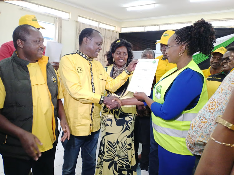 Embu gubernatorial candidate Lennya Kivuti receives the Iebc clearance certificate from County Returning Officer Agnes Mutisya at Embu on Monday June 7,2022.