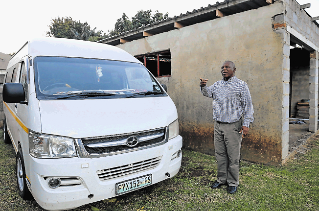 Retired magistrate Makhosi Mantantana points at a Toyota Quantum which he suspects his son stole