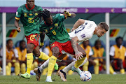 Andre-Frank Zambo Anguissa of Cameroon challenges Sergej Milinkovic-Savic of Serbia in the World Cup Group G match at Al Janoub Stadium on November 28 2022.