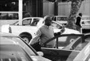 SMILING:Advocate Letsepe Thubakgale was suspended for 60 days by Polokwane Municipality as a Municipal Manager. Sowetan photographer took  a picture of him leaving  his office on his first day after suspension. Pic: ELIJAR MUSHIANA. 29/07/2009. © Sowetan