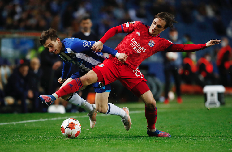 Olympique Lyonnais' Maxence Caqueret in action with Porto's Francisco Conceicao