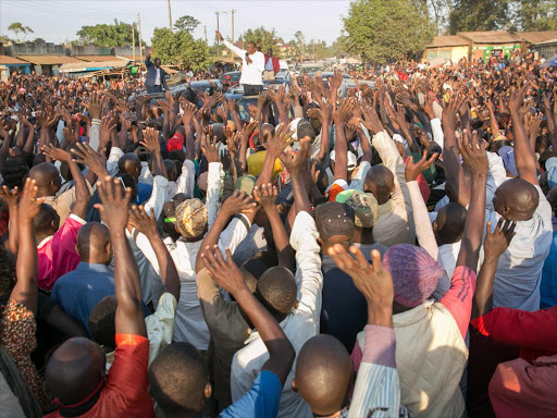 President Uhuru Kenyatta and Deputy President William Ruto address residents of Kakamega town enroute to Kakamega County Referral Hospital.Photo/PSCU