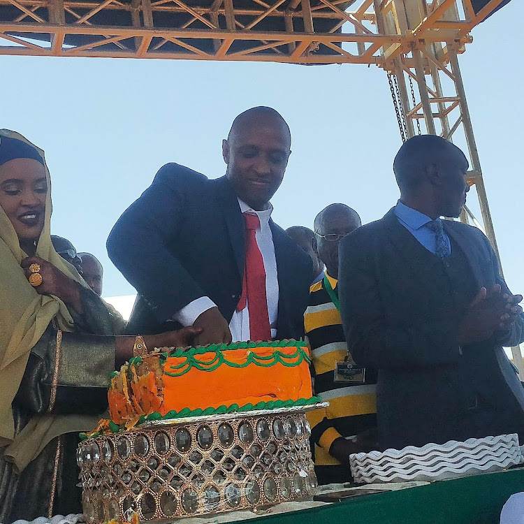 Isiolo Governor Abdi Hassan Guyo and his wife Habiba Galgalo Hassan cutting a cake during the swearing in ceremony at the Isiolo Boys High School on August 25,2022.