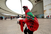 A man draped in an EFF flag arrives at  the party's manifesto launch at Moses Mabhida Stadium, Durban, on Saturday ahead of the general elections this year. 