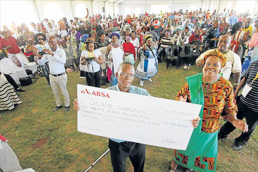 CASH FOR LAND: Qelana Land Claim Committee chairman Khanyisile Ndzungu, left, proudly displays a cheque of more than R27-million with national Chief Land Claims Commissioner Nomfundo Ntloko-Gobodo at KwaTshemese near Mthatha Picture: LULAMILE FENI