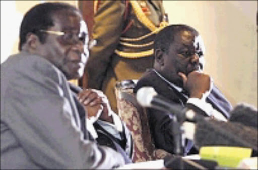 TENSIONS: Morgan Tsvangirai and Robert Mugabe. 17/02/09. © Unknown.