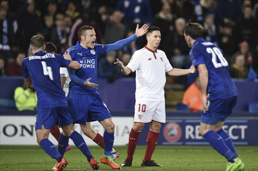 Leicester City's English striker Jamie Vardy (2L) and Sevilla's French forward Samir Nasri (2R) react after an off the ball incident that saw both players receive a yellow card, which was Nasri's second yellow card of the match, during the UEFA Champions League round of 16 second leg football match between Leicester City and Sevilla at the King Power Stadium on March 14, 2017.