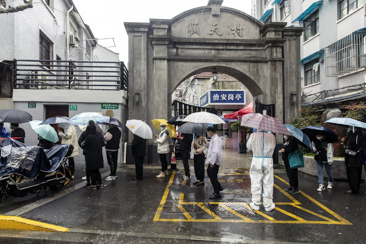 Residents queue at a Covid-19 testing facility in Shanghai, China, on March 25 2022. Picture: BLOOMBERG/QILAI SHEN