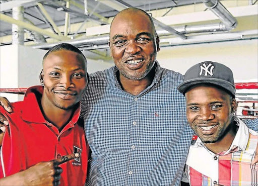 Manager Mla Tengimfene is flanked by the Tete brothers Zolani Tete, left, and Makazole