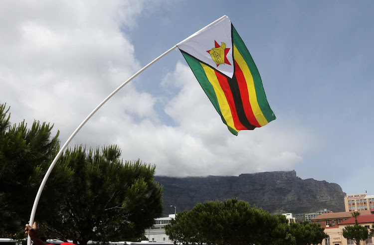 Dozens of Zimbabweans in Cape Town have taken to the Grand Parade to call for President Robert Mugabe’s demise. Image: ESA ALEXANDER