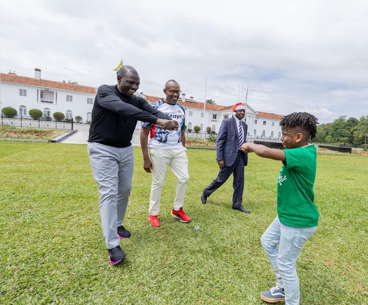 President William Ruto interacts with children during a Christmas party at State House Nairobi on December 19, 2023.