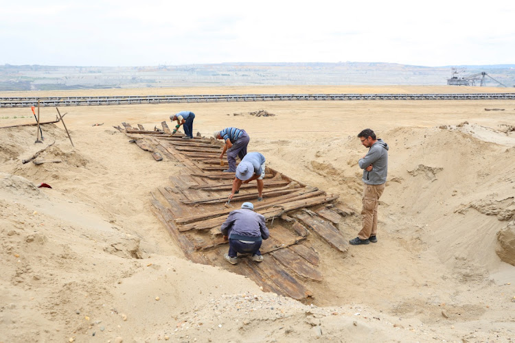 Archaeologists excavate the hull of a wooden ship, an ancient Roman flat-hulled riverine vessel at the ancient city of Viminacium, near Kostolac, Serbia, August 2, 2023.