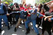 Police officers had their hands full yesterday as supporters for and against  controversial televangelist Timothy Omotoso clashed outside the Port Elizabeth high court. 