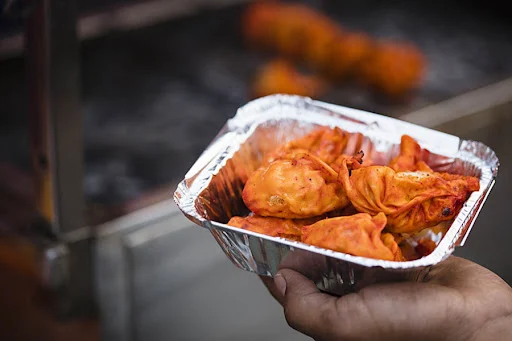 Pan Fried Corn Cheese Momos In Schezwan Sauce [6 Pieces]