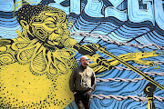 Lance McCormack of Flame Studios celebrates the creative economy taking root at Con Hill. The mural is by artist Mook Lion.