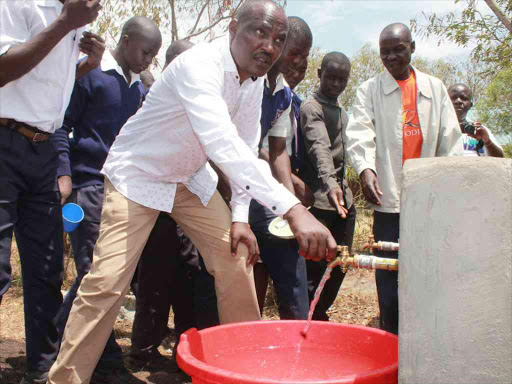 Suba MP John Mbadi and Seka students test the flow of water in school on Friday.The water project was done at a cost of sh4.7million on September 11,2016.Photo Robert Omollo